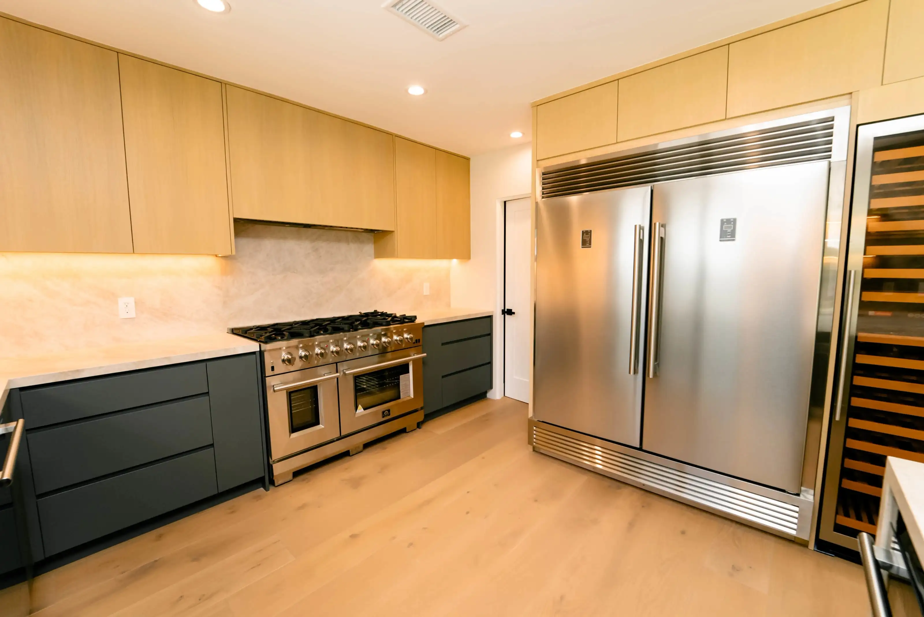 Open-concept kitchen renovation in San Jose with large sliding glass doors, island counter, and seamless flow to the living area.