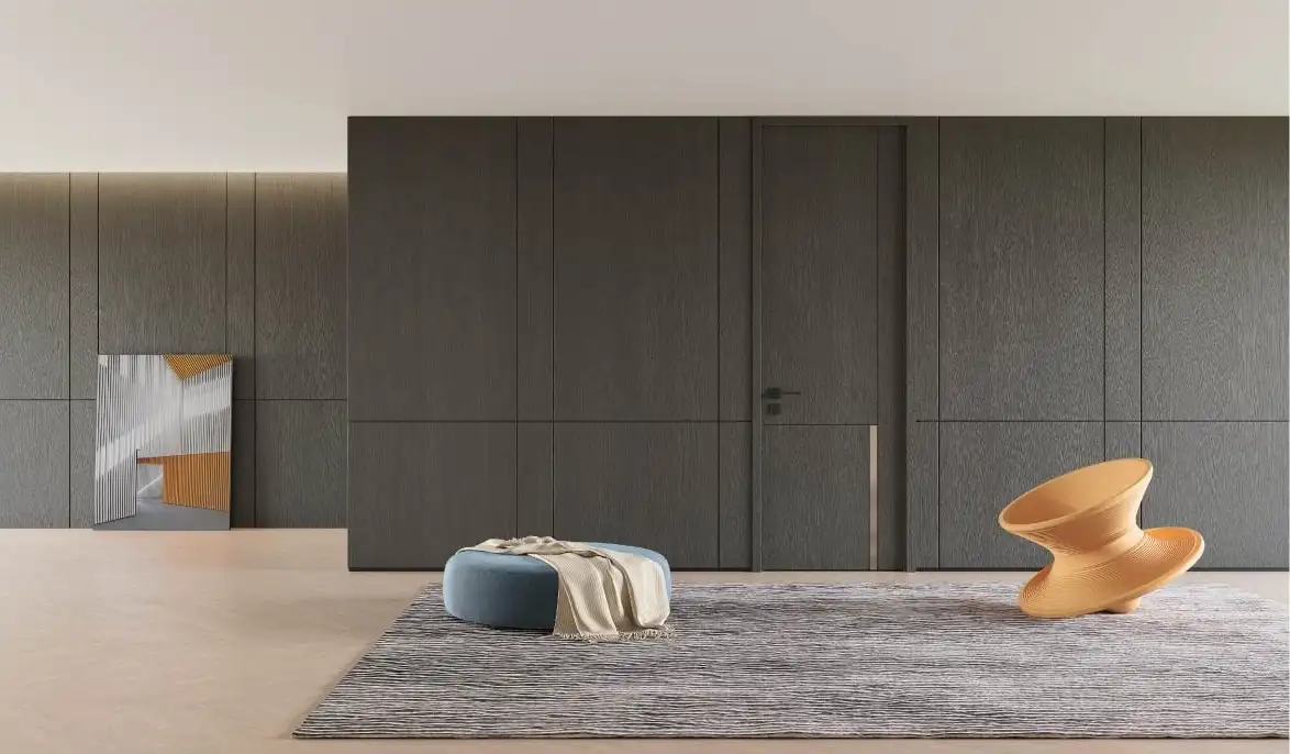 Grey full-height wall paneling with a concealed flush door in an open living space