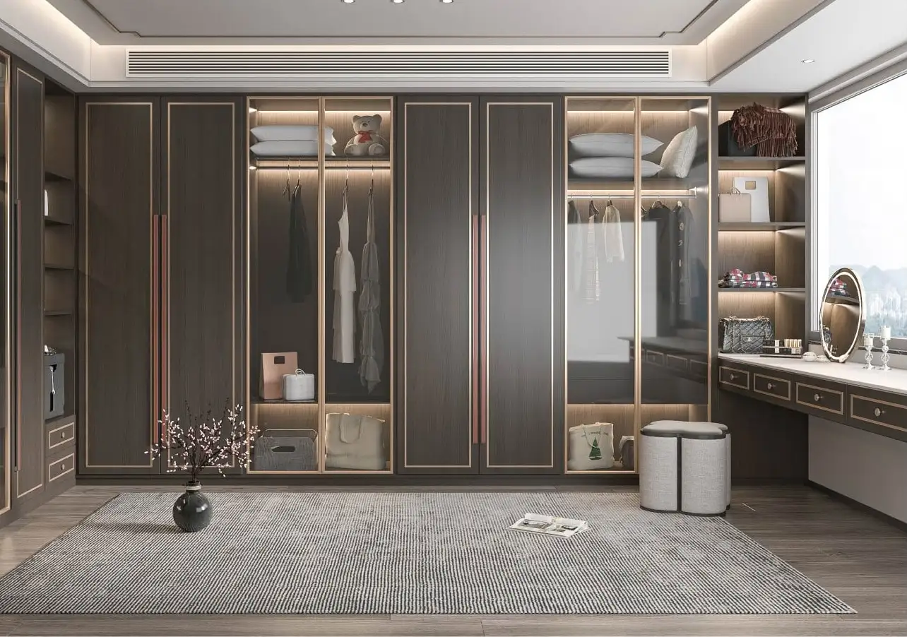 Dark bronze dressing room with glazed wardrobes, a dressing table and drawer banks